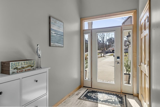11262 Lemott Cir, Jerome, MI 49249 - doorway to outside with baseboards and light wood-style floors