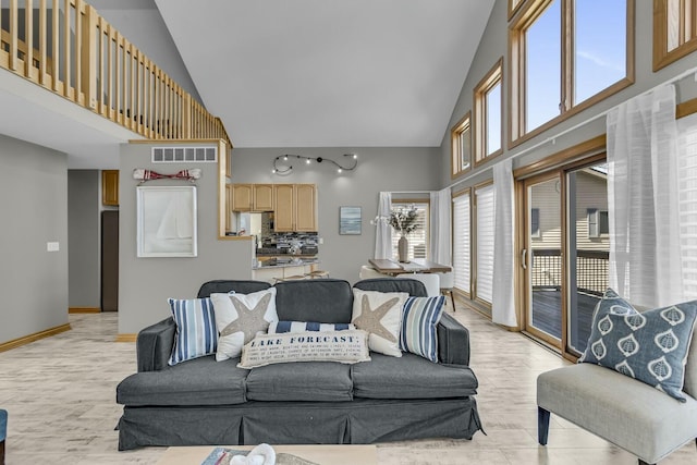 11262 Lemott Cir, Jerome, MI 49249 - living area with baseboards, visible vents, high vaulted ceiling, and light wood-style floors