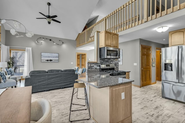 11262 Lemott Cir, Jerome, MI 49249 - kitchen with ceiling fan, stainless steel appliances, light wood-type flooring, and a breakfast bar area