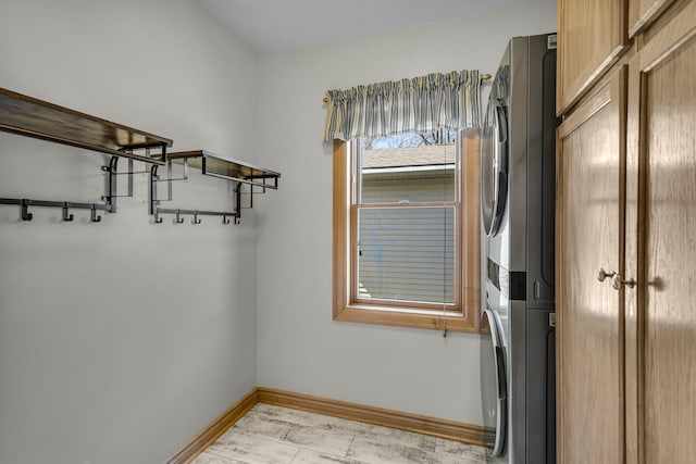 11262 Lemott Cir, Jerome, MI 49249 - interior space featuring baseboards, light wood-style flooring, stacked washer / dryer, and laundry area