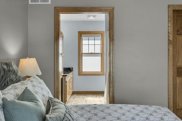 11262 Lemott Cir, Jerome, MI 49249 - bedroom with baseboards, light wood finished floors, and visible vents