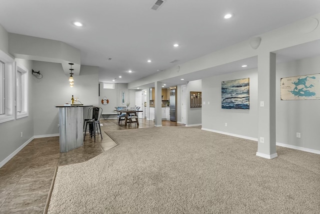 11262 Lemott Cir, Jerome, MI 49249 - unfurnished living room featuring baseboards, visible vents, recessed lighting, and indoor bar