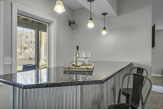 11262 Lemott Cir, Jerome, MI 49249 - kitchen with dark stone counters, a kitchen breakfast bar, and decorative light fixtures