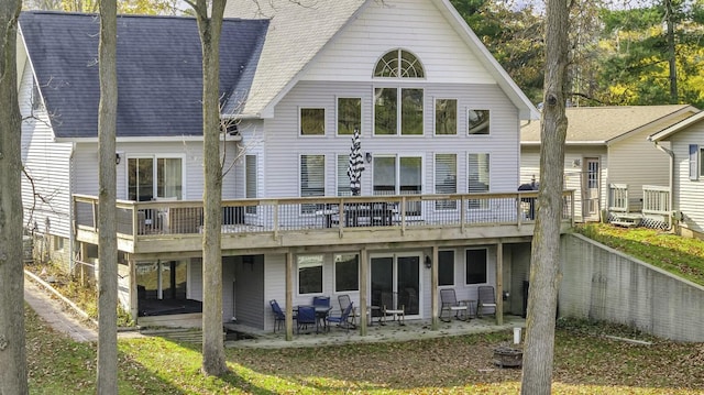11262 Lemott Cir, Jerome, MI 49249 - rear view of property featuring a patio, a shingled roof, and a deck