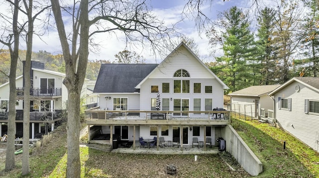 11262 Lemott Cir, Jerome, MI 49249 - rear view of house with a shingled roof, a deck, and a patio area