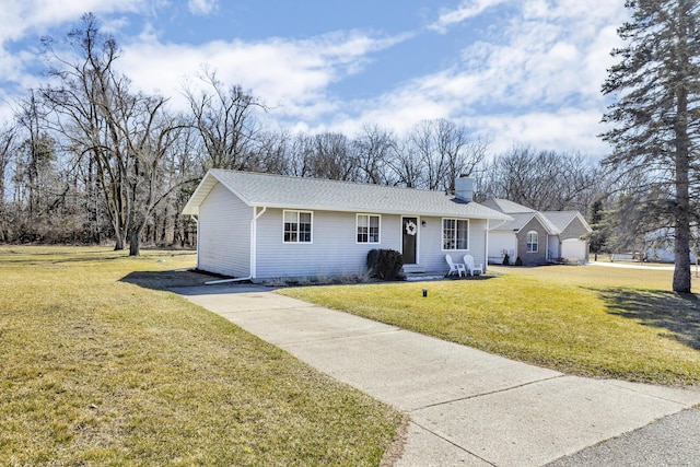 single story home with driveway, a chimney, a shingled roof, and a front yard
