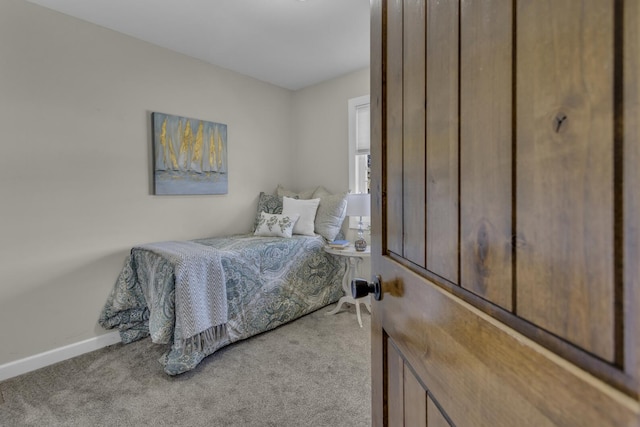 bedroom featuring baseboards and carpet floors