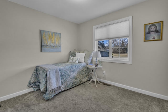 carpeted bedroom with baseboards and visible vents