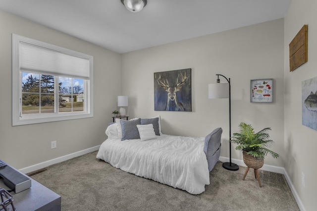 carpeted bedroom featuring baseboards and visible vents
