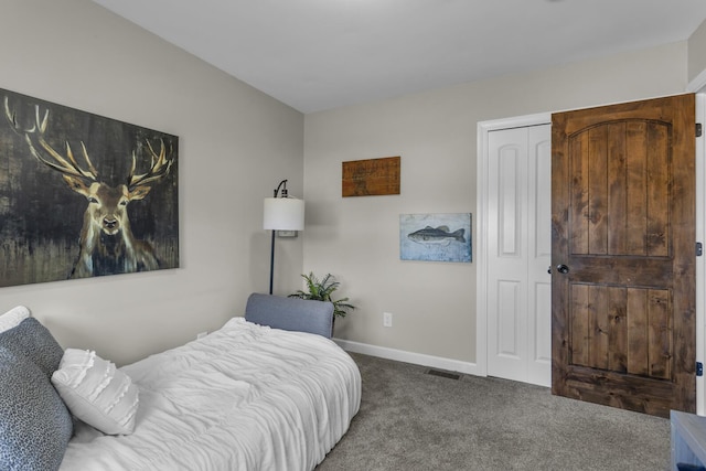 carpeted bedroom with a closet, baseboards, and visible vents