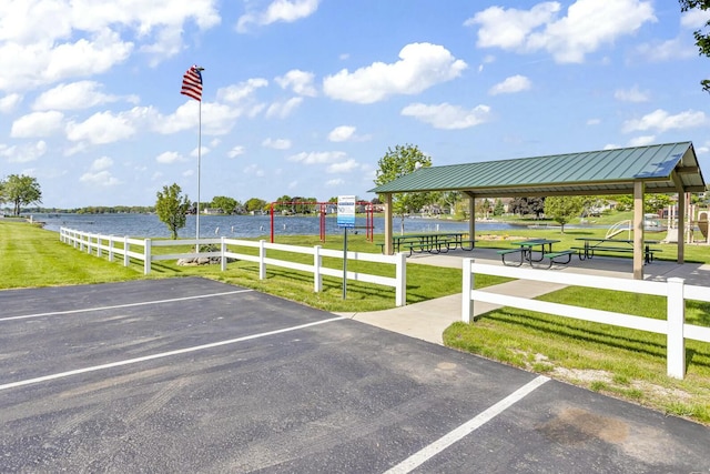 uncovered parking lot with a water view and a gazebo