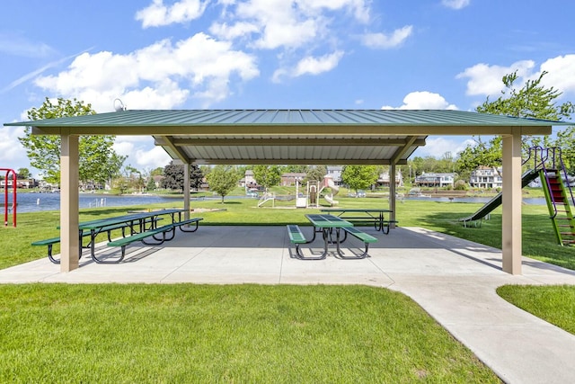 view of home's community with playground community and a lawn