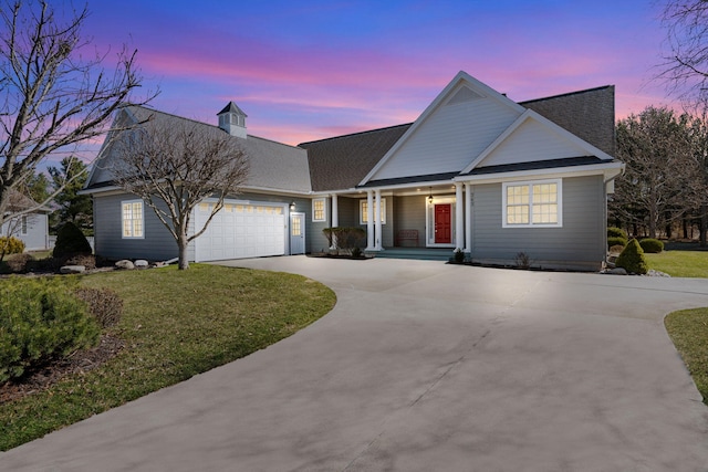 view of front of property featuring a front lawn, driveway, a shingled roof, and an attached garage