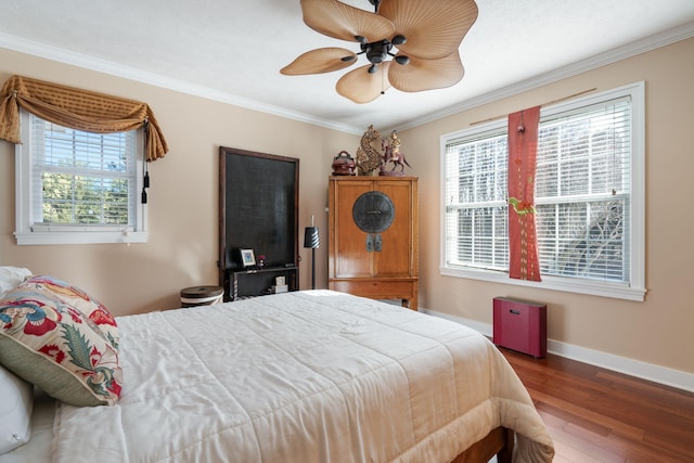 bedroom with a ceiling fan, ornamental molding, baseboards, and wood finished floors