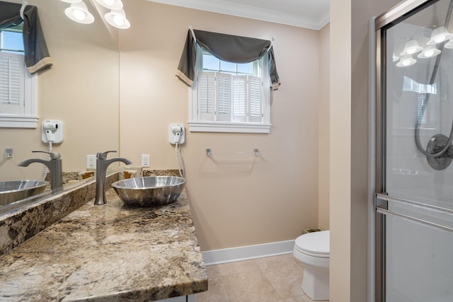 full bathroom with vanity, toilet, ornamental molding, baseboards, and a shower stall