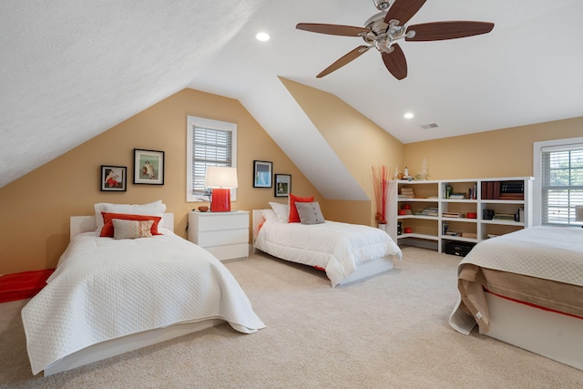 bedroom featuring lofted ceiling, recessed lighting, a textured ceiling, carpet floors, and ceiling fan