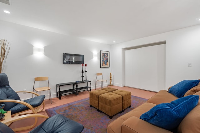 living area featuring baseboards and recessed lighting