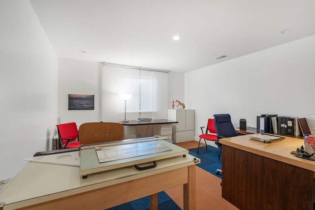 carpeted office space with visible vents and recessed lighting