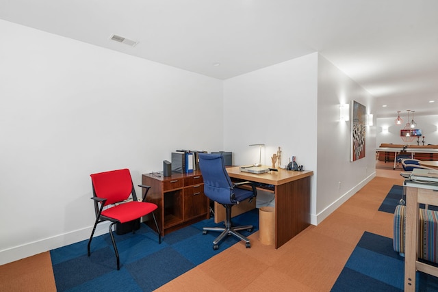 office space featuring baseboards, carpet floors, and visible vents