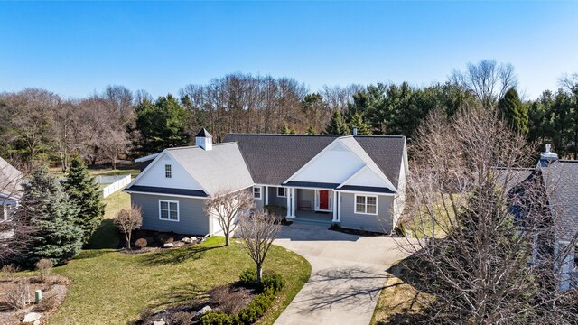 ranch-style home featuring a front lawn and concrete driveway