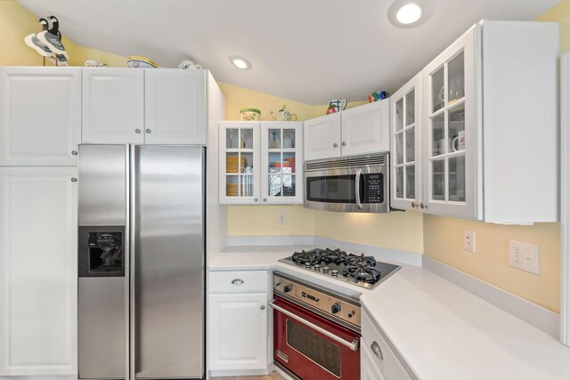 4103 Lake Shore Dr, New Buffalo, MI 49117 - kitchen featuring glass insert cabinets, stainless steel appliances, light countertops, white cabinets, and recessed lighting