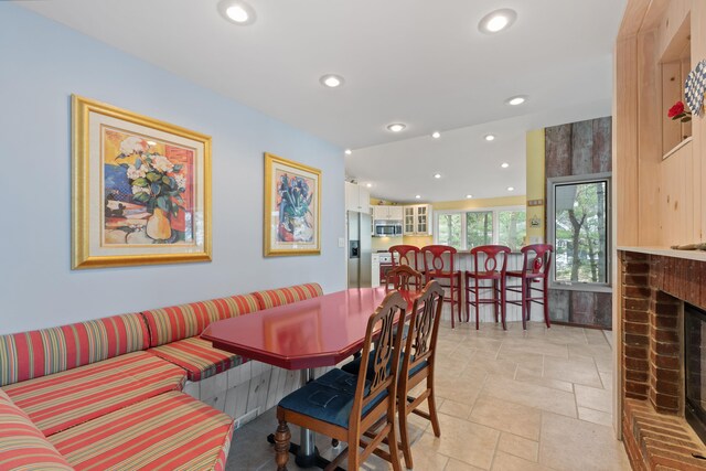 4103 Lake Shore Dr, New Buffalo, MI 49117 - dining room featuring recessed lighting, stone tile flooring, and a brick fireplace