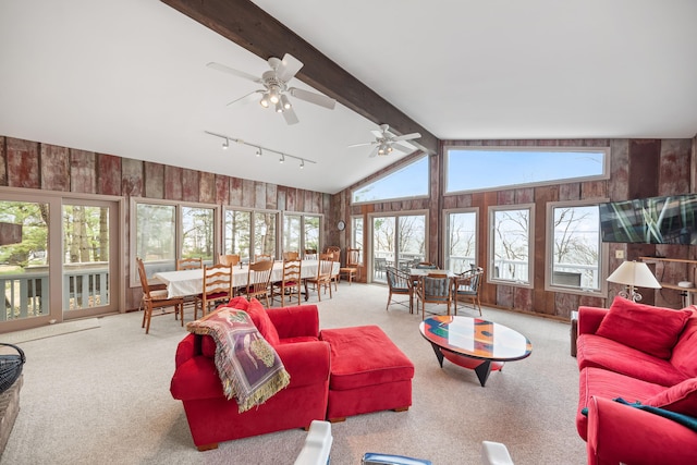4103 Lake Shore Dr, New Buffalo, MI 49117 - carpeted living area with wooden walls, ceiling fan, and lofted ceiling with beams