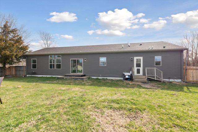 19372 M 140, South Haven, MI 49090 - rear view of house featuring entry steps, fence, and a lawn