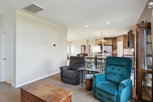 19372 M 140, South Haven, MI 49090 - living area featuring visible vents, baseboards, recessed lighting, ceiling fan with notable chandelier, and light colored carpet