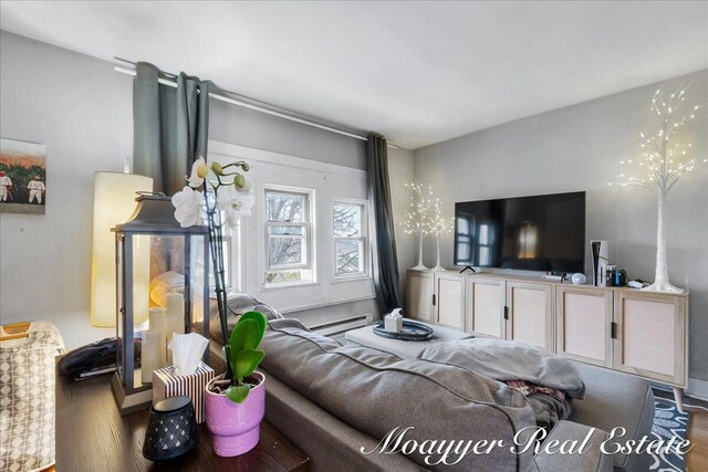 1403 Turner Ave NW, Grand Rapids, MI 49504 - living area with wood finished floors and a baseboard heating unit