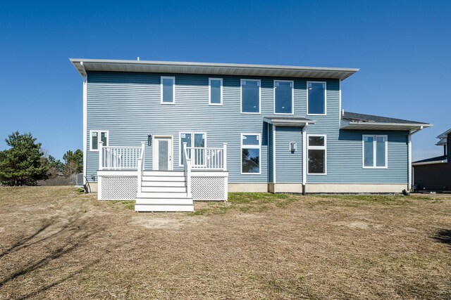 back of property featuring a wooden deck