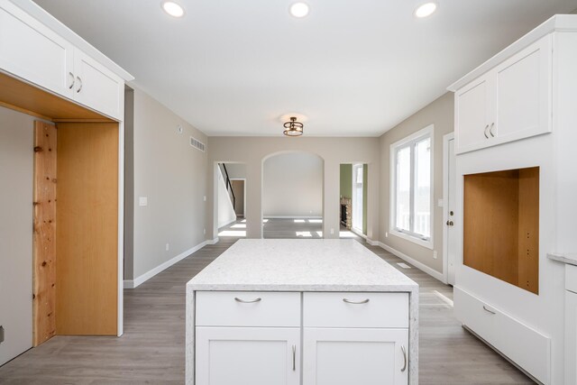 kitchen with light wood-type flooring, recessed lighting, and white cabinetry