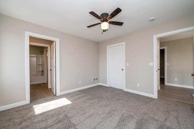 unfurnished bedroom featuring ceiling fan, baseboards, carpet flooring, and visible vents
