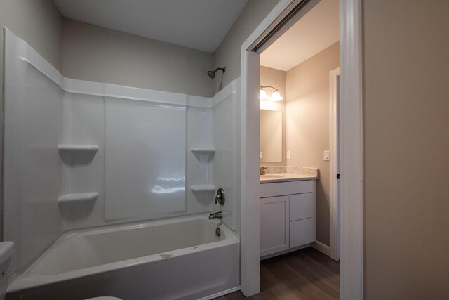 full bathroom featuring bathing tub / shower combination, wood finished floors, vanity, and toilet