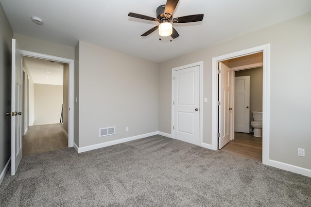 unfurnished bedroom with carpet floors, visible vents, a ceiling fan, and baseboards