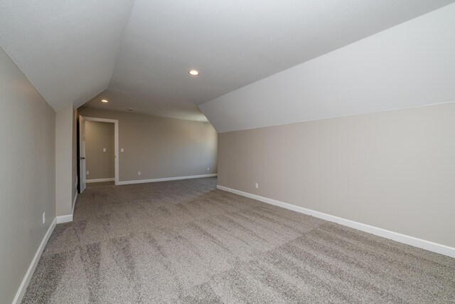 bonus room featuring baseboards, vaulted ceiling, carpet floors, and recessed lighting