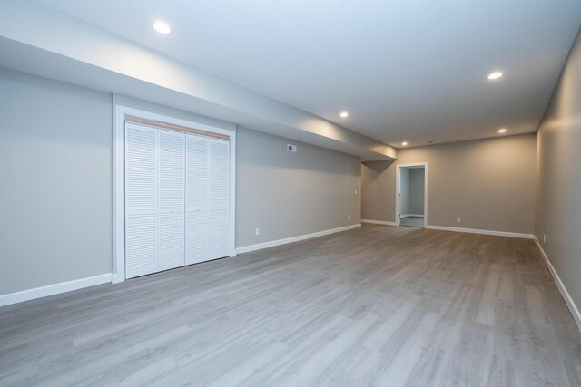 finished below grade area with recessed lighting, wood finished floors, and baseboards