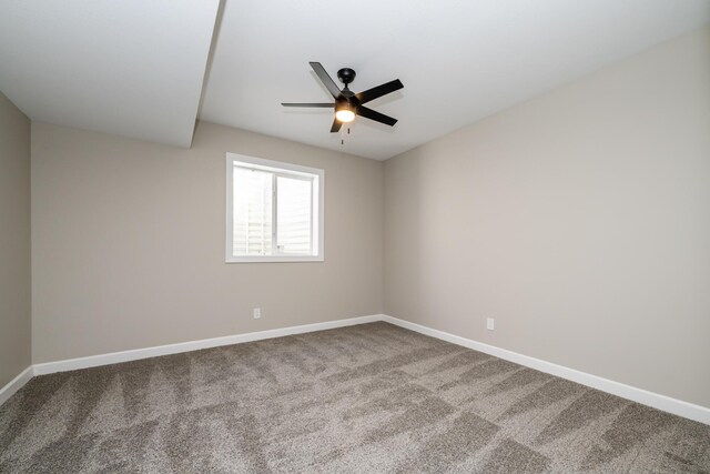spare room with carpet floors, baseboards, and ceiling fan