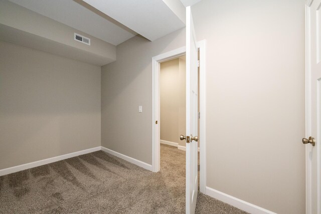 interior space featuring baseboards, visible vents, and carpet floors