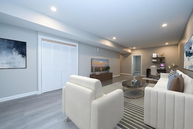 living room with recessed lighting and baseboards