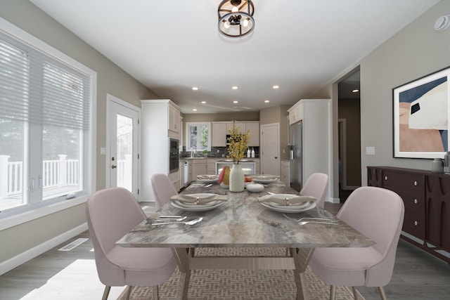 dining area featuring recessed lighting, wood finished floors, visible vents, and baseboards