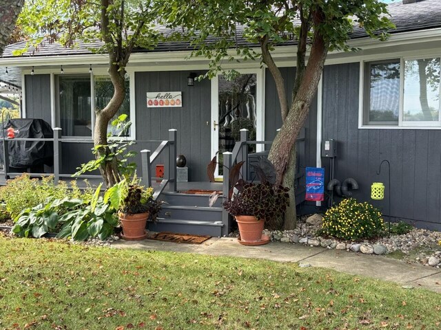 doorway to property with a yard