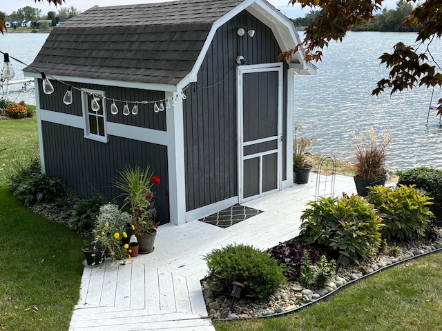view of shed with a water view