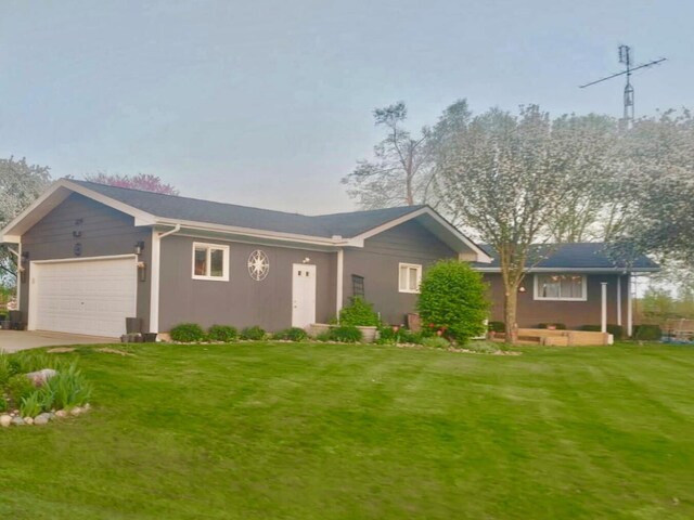 single story home featuring stucco siding, concrete driveway, a front lawn, and an attached garage