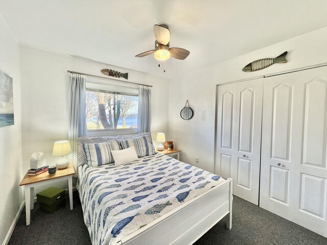 bedroom featuring baseboards, a closet, dark carpet, and a ceiling fan