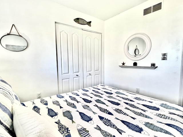 bedroom featuring a closet and visible vents