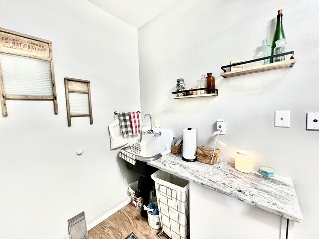 bathroom featuring baseboards and wood finished floors