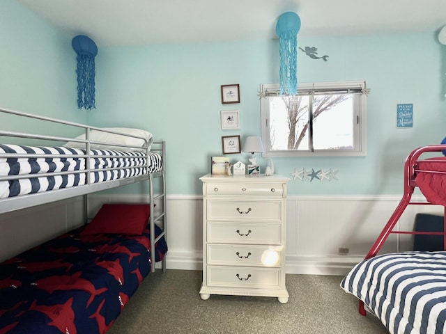 bedroom with a wainscoted wall