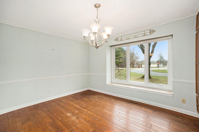 17650 Woodbridge Rd # 1, Spring Lake, MI 49456 - unfurnished room featuring a chandelier, ornamental molding, dark wood-type flooring, and baseboards