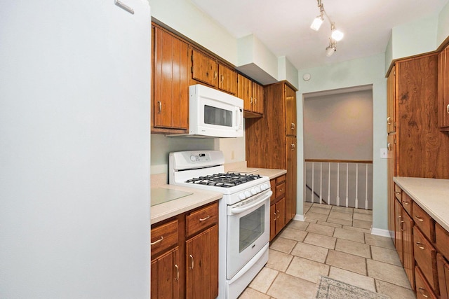 17650 Woodbridge Rd # 1, Spring Lake, MI 49456 - kitchen featuring white appliances, brown cabinets, and light countertops